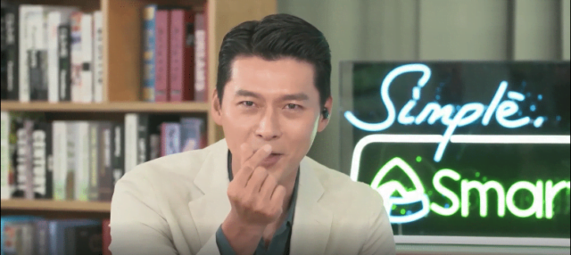 Hyun Bin gives his fans a finger heart sign to show his love. 