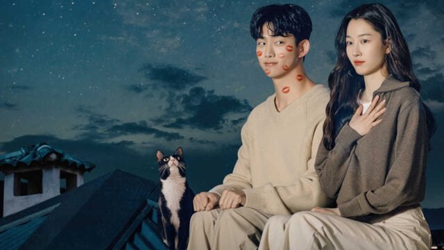 Detail from the poster of "HeartBeat": A cat, Ok Taec-yeon, and Won Ji-an sitting on a house's roof with moon and stars on the background